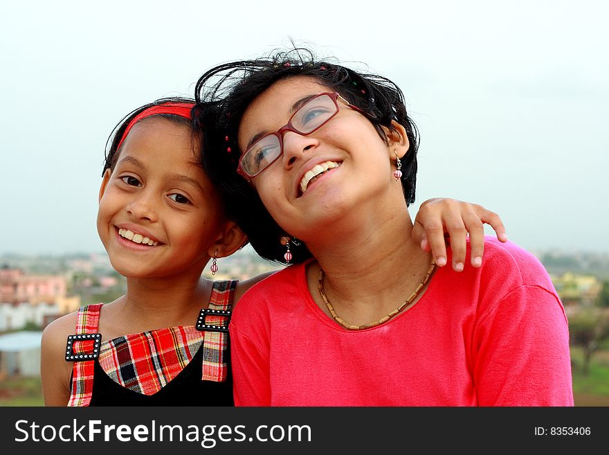 Two Indian girls smiling happily in a jolly good mood. Two Indian girls smiling happily in a jolly good mood.