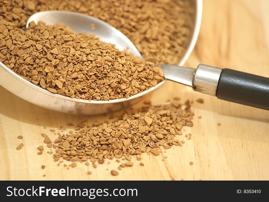 A macro view of coffee granules and a spoon. A macro view of coffee granules and a spoon