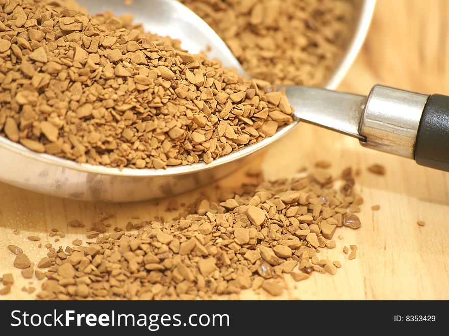 A macro view of coffee granules and a spoon. A macro view of coffee granules and a spoon