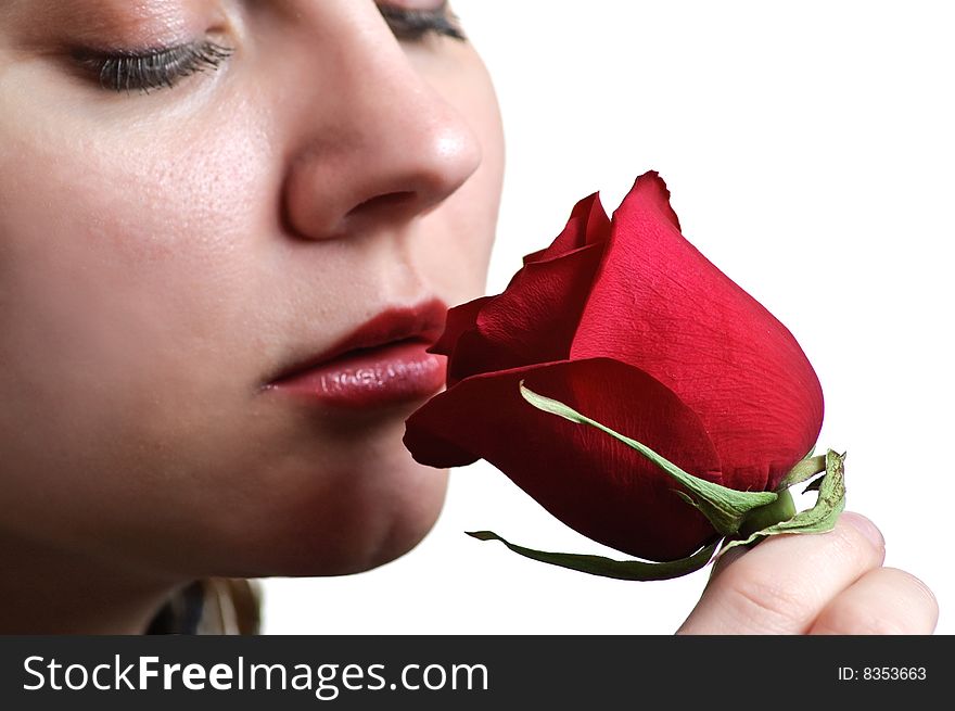 Woman sniffing red rose on white background