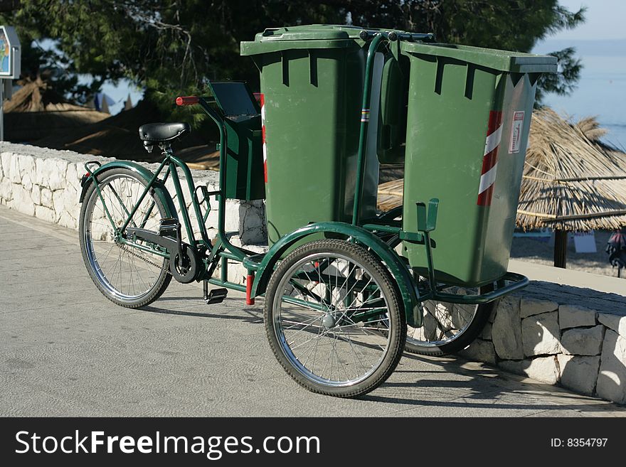 Two green plastic containers for garbage on wheels. Two green plastic containers for garbage on wheels