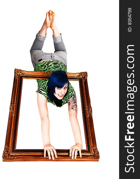An young girl with blue hair laying on the stomach on the floor holding a picture frame over her body on white background. An young girl with blue hair laying on the stomach on the floor holding a picture frame over her body on white background.