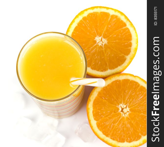 Oranges, ice and juice in glass on white