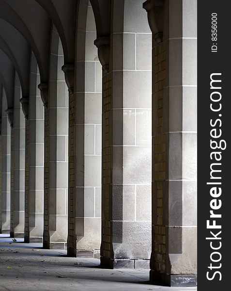 Row of Repeating Columns with Sunlight Shining Through