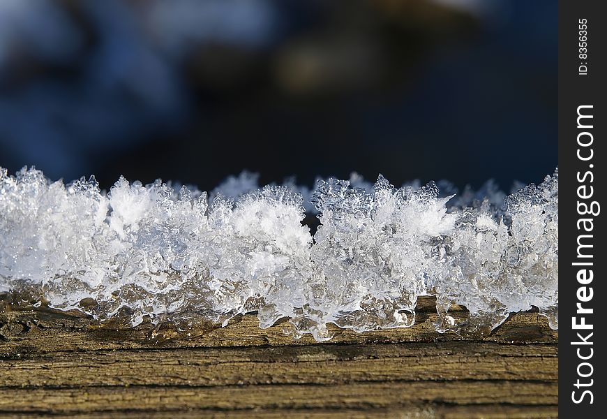 Melting snow at wooden plank