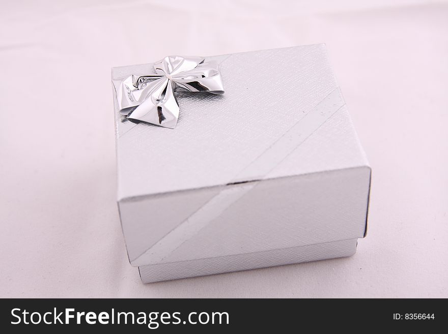 Small cardboard silver colored box for jewelry. Small cardboard silver colored box for jewelry