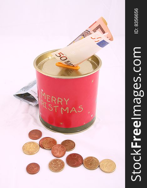 Christmas savings, euro bills and coins with velvet decorations
