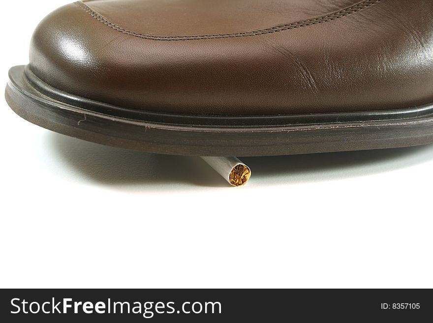 On a white background, shoes stepped on a cigarette