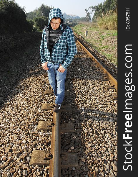 Handsome man waiting for the train on a railway. Handsome man waiting for the train on a railway