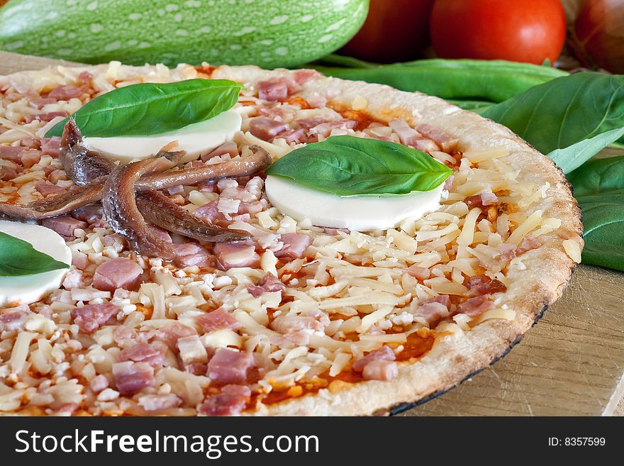 Delicious pizza with cheese and anchovy on decorated platter
