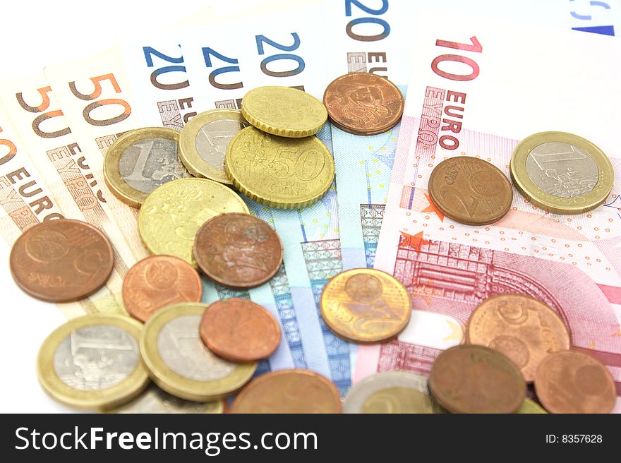 Euro coins and banknotes isolated over white. Euro coins and banknotes isolated over white