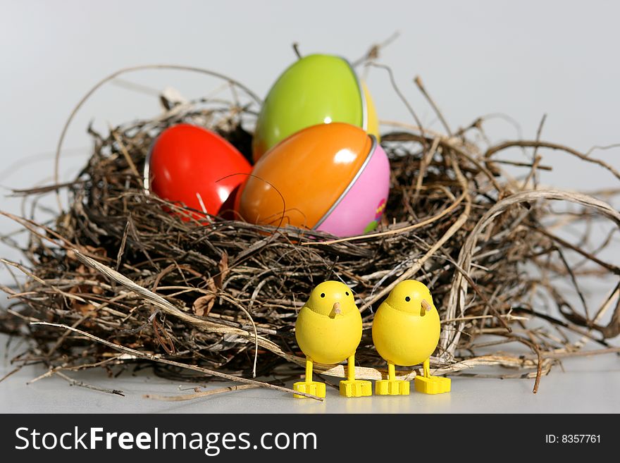 Colorful eggs in a birds nest with Eastr decoration. Colorful eggs in a birds nest with Eastr decoration