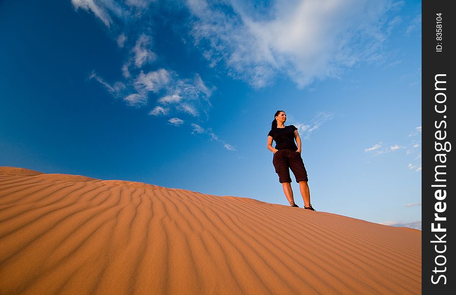 Woman admiring Coral Pink Sand Dunes State Park in Utah. Woman admiring Coral Pink Sand Dunes State Park in Utah