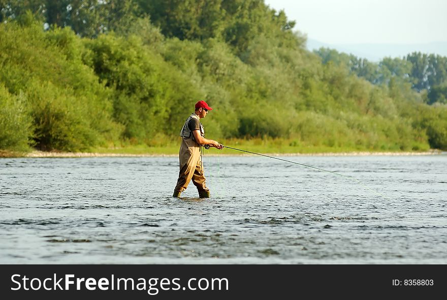 Fisherman angling on the river