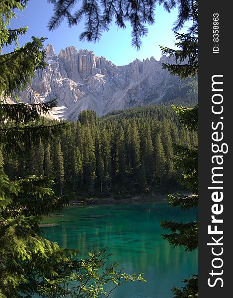 Mountain lake in the dolomites framed by trees. Mountain lake in the dolomites framed by trees
