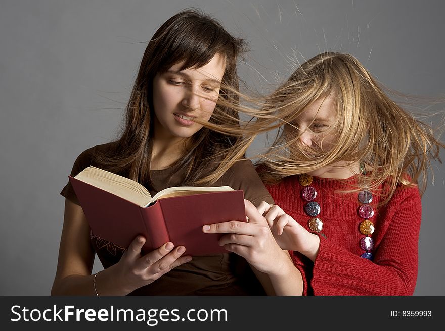 Two teenagers read the book. Two teenagers read the book