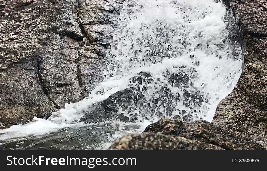 Waterfall Through Big Rocks close up in slow motion. Waterfall Through Big Rocks close up in slow motion