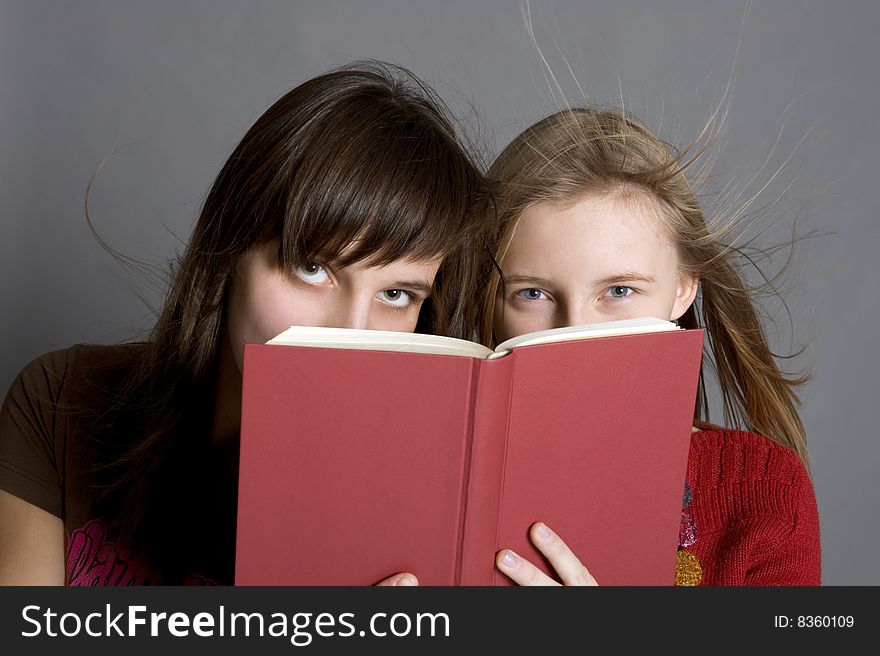 Two teenagers read the book. Two teenagers read the book