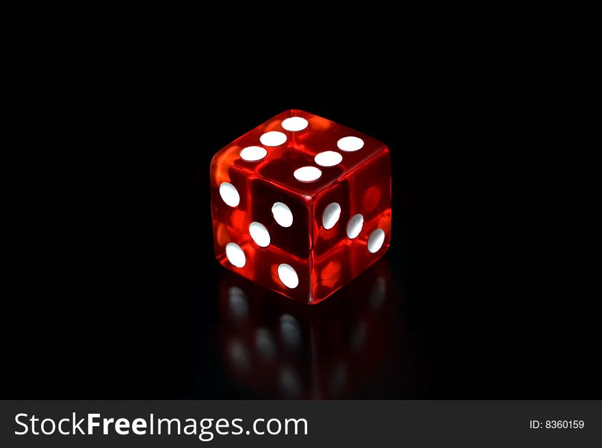A dice on a black background.