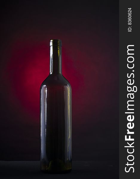 Bottle of wine on red smoke background
