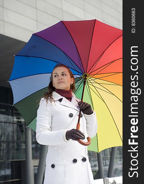 Woman with umbrella in the colors of the rainbow