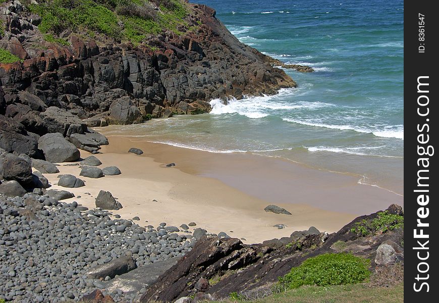 A small but secluded prisitne beach with a rocky outcropping on the northern NSW coastline of Australia. A small but secluded prisitne beach with a rocky outcropping on the northern NSW coastline of Australia.