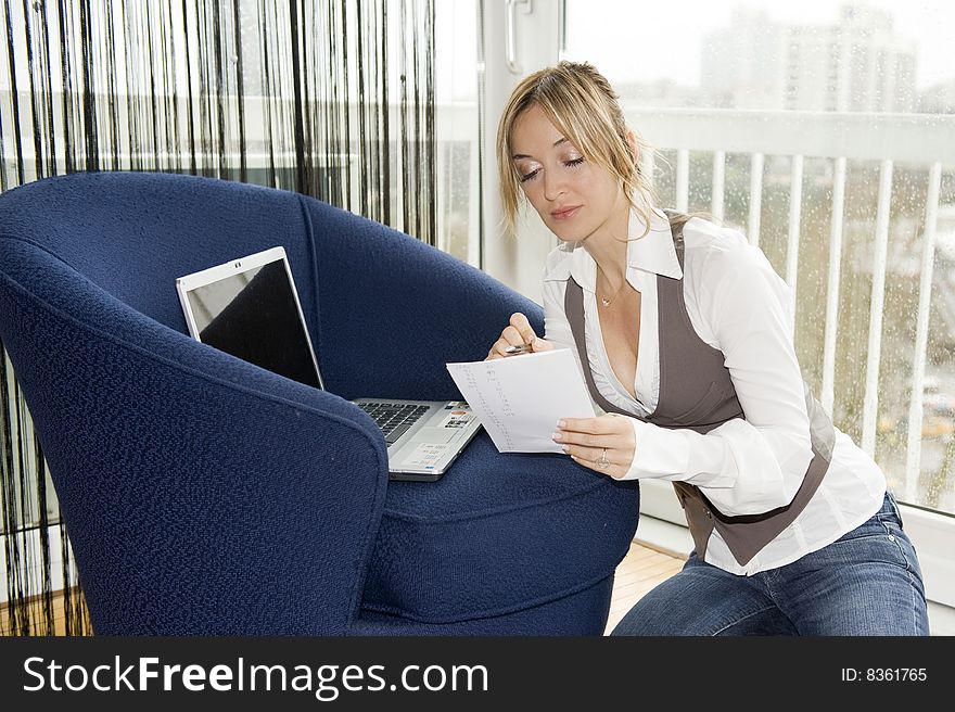 Woman studying at home on a rainy day. Woman studying at home on a rainy day