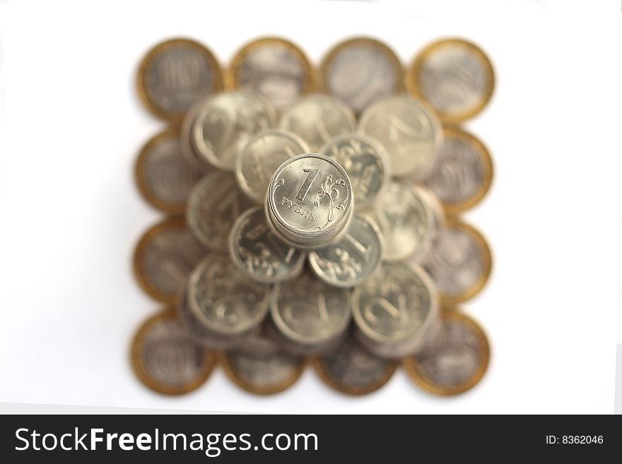 Pyramid of coins isolated on white background from above