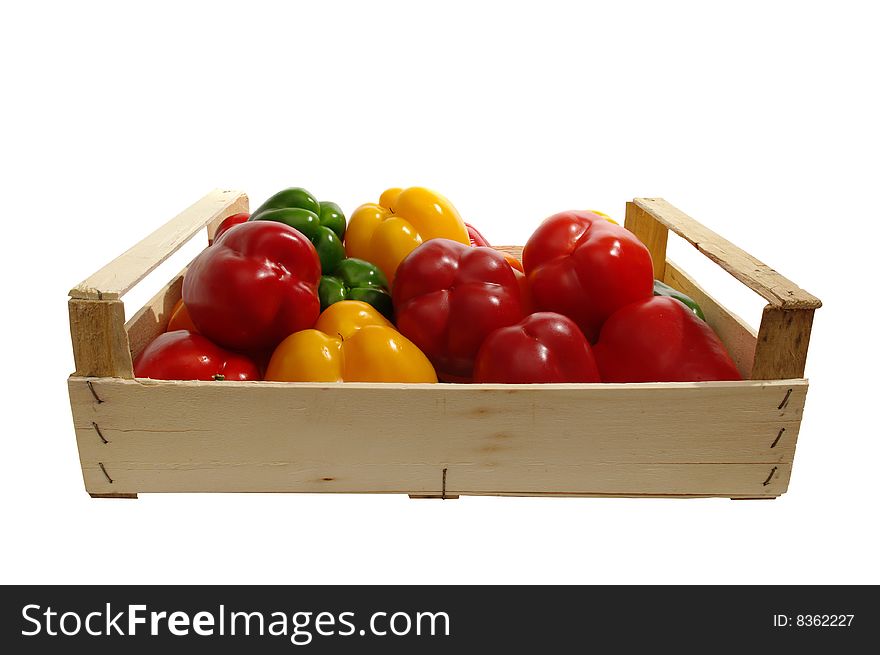 A wooden box with paprika is on white background. A wooden box with paprika is on white background