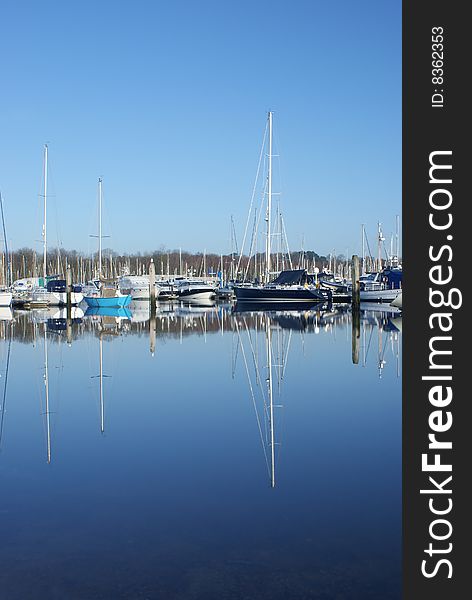 Image of yachts reflected in water. Image of yachts reflected in water