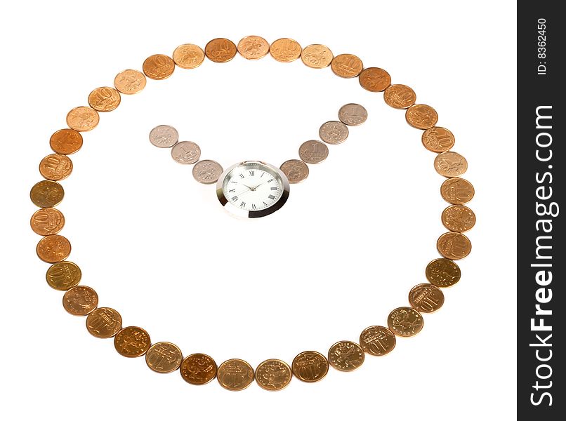 A clock made of coins on the white background with a watch in the centre. A clock made of coins on the white background with a watch in the centre