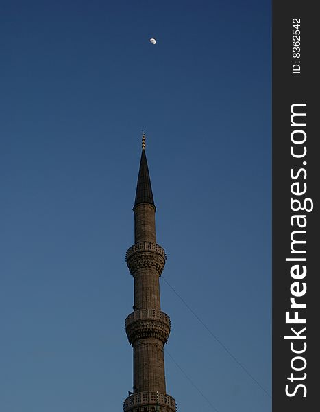 Muslim symbol of a minaret with moon on sky. Muslim symbol of a minaret with moon on sky