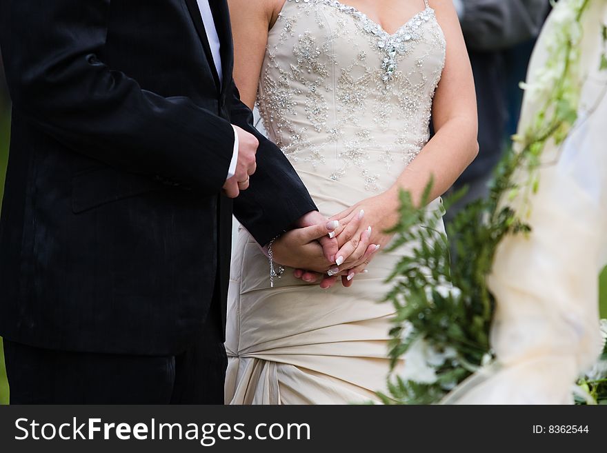 Young groom hold his bride hand at wedding party. Young groom hold his bride hand at wedding party