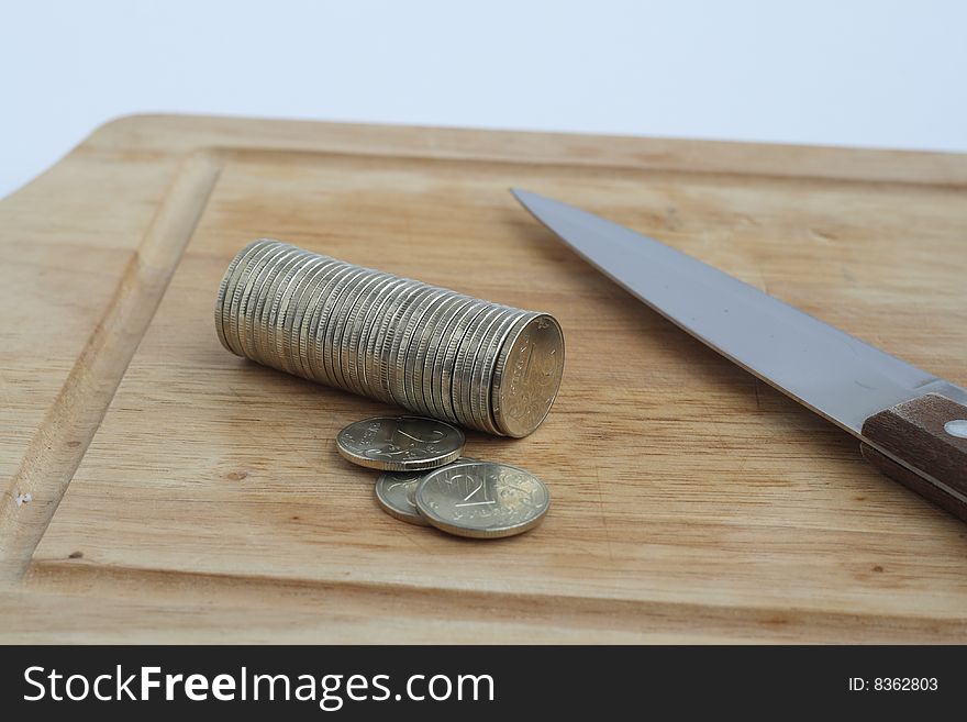 Stack of coins with knife