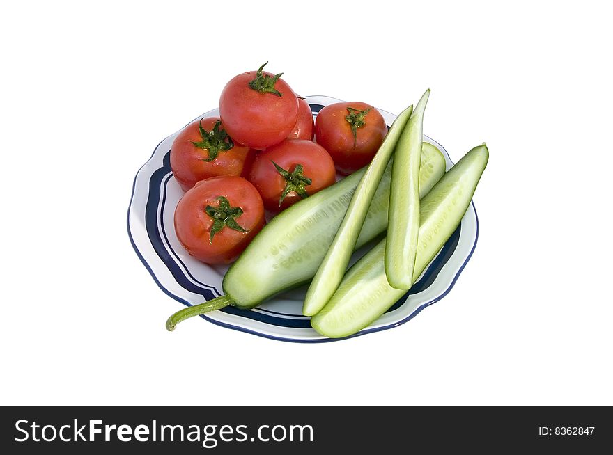 Tomato & cucumber on a plate over white background