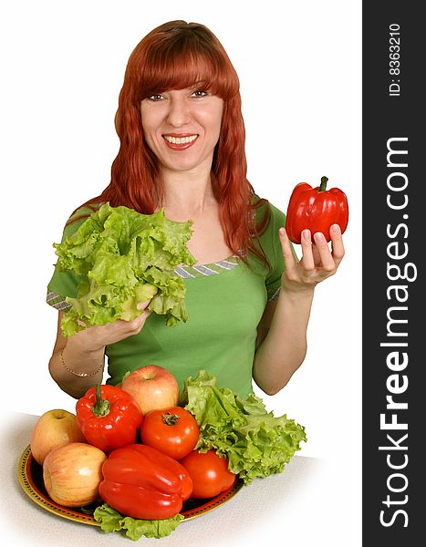 The woman is pleased to fresh vegetables on a white background. The woman is pleased to fresh vegetables on a white background