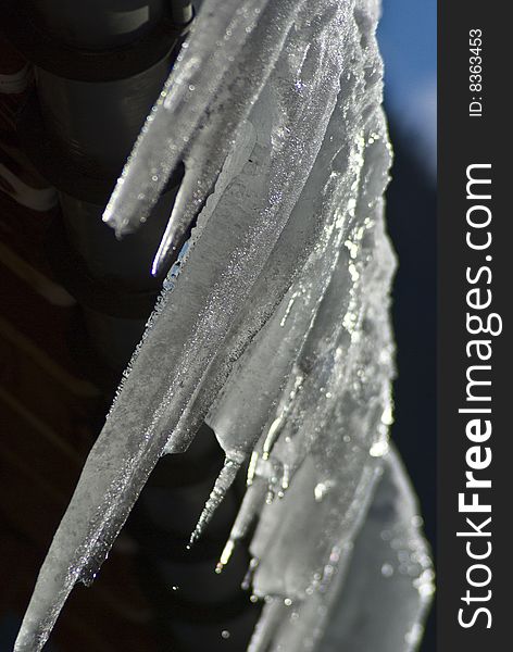 Swiss chalet roof with huge icicles formed over night after the thaw had reversed. Swiss chalet roof with huge icicles formed over night after the thaw had reversed