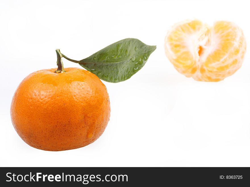 Tangerine with leaves on white background.