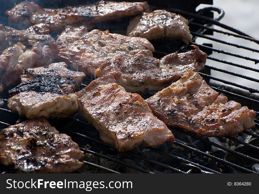 Delicious looking steaks cooking on the grill. Delicious looking steaks cooking on the grill