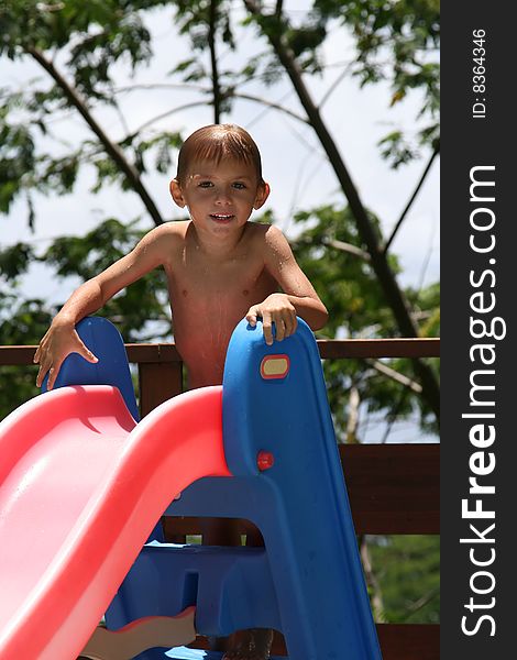 Boy on a water slide, in summer time