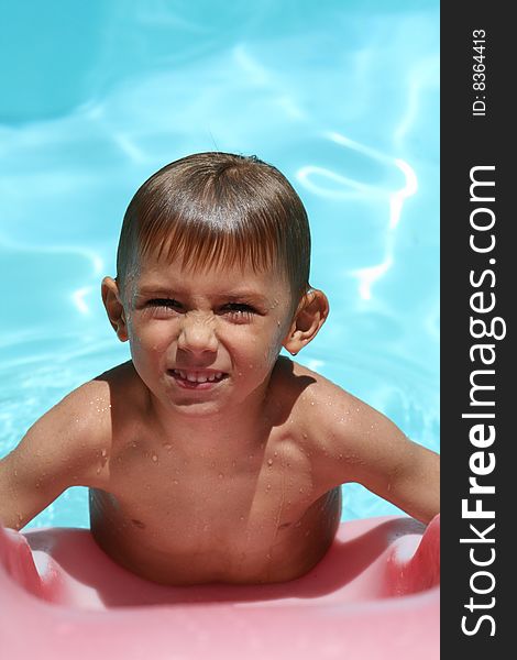 Boy frowning in a swimming pool