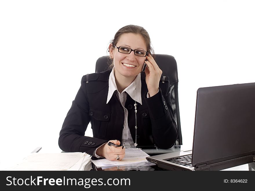 A young business woman working in her office. A young business woman working in her office