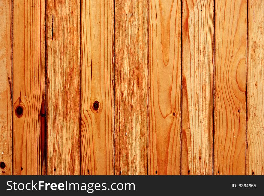 Wooden fence made of unfinished pine boards