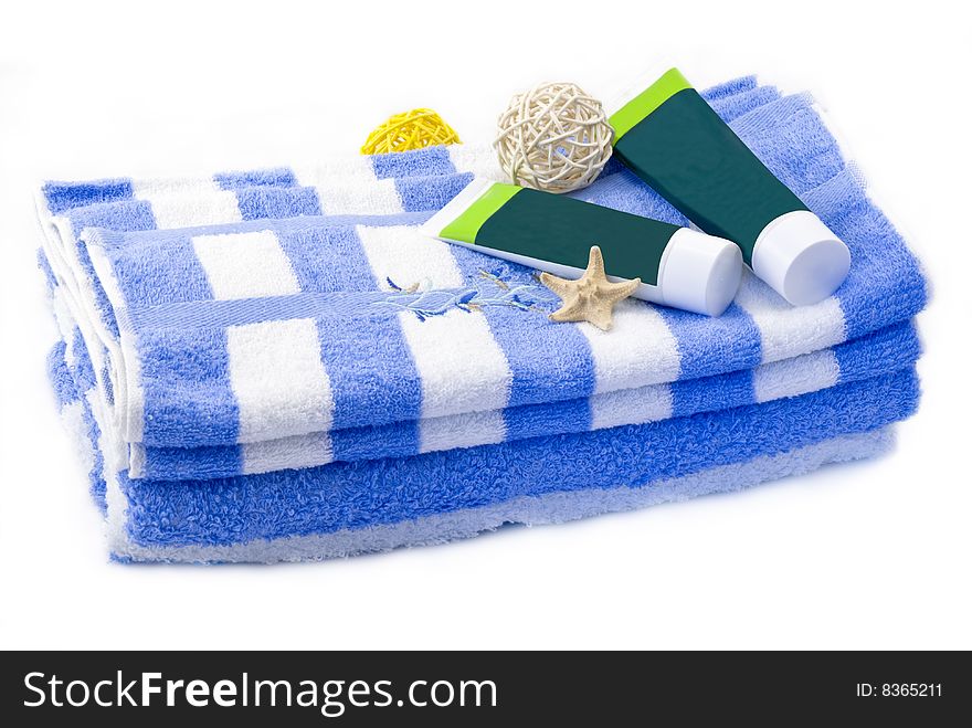 Striped towels with creams isolated on white background
