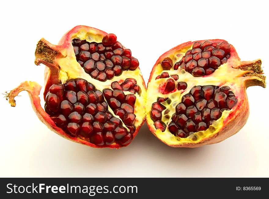 Cut pomegranate on a white background