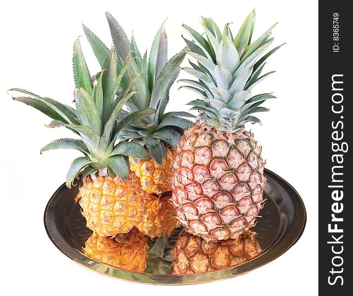 three whole pineapple on a tray