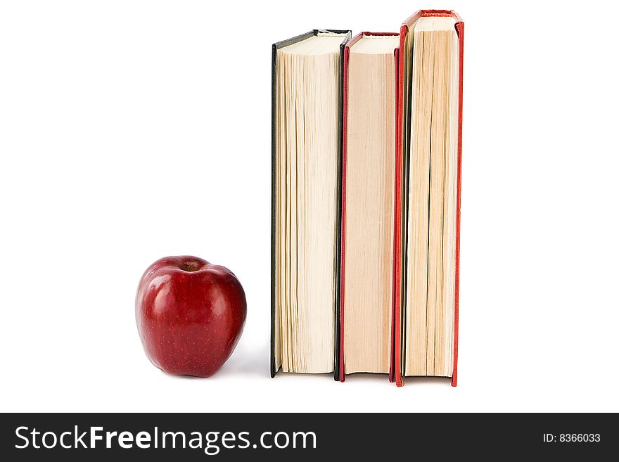 Red apple and books isolated on white. Red apple and books isolated on white