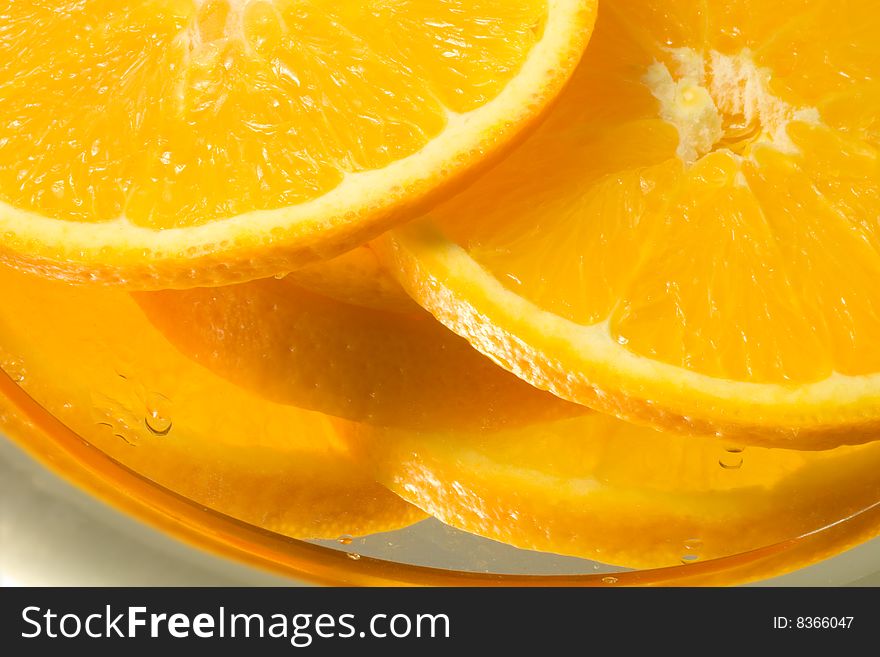 Bright orange slices on a reflecting surface