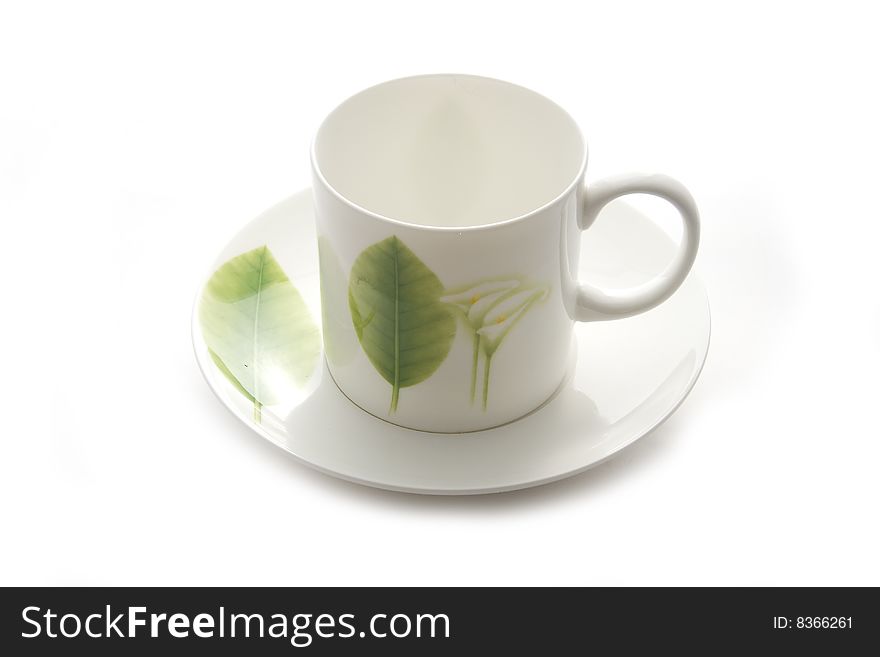 White coffee cup with green leaf