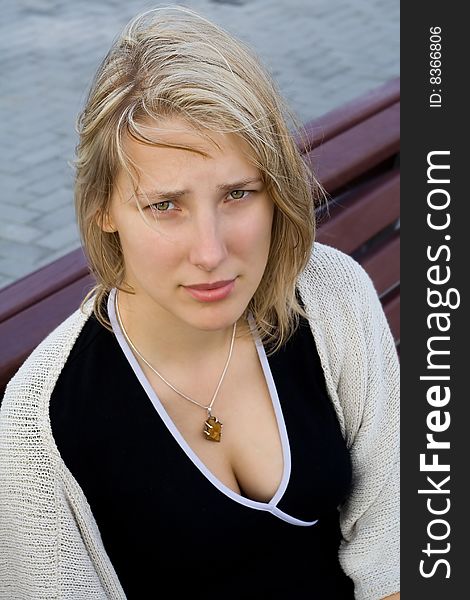 Pretty girl sitting on a bench